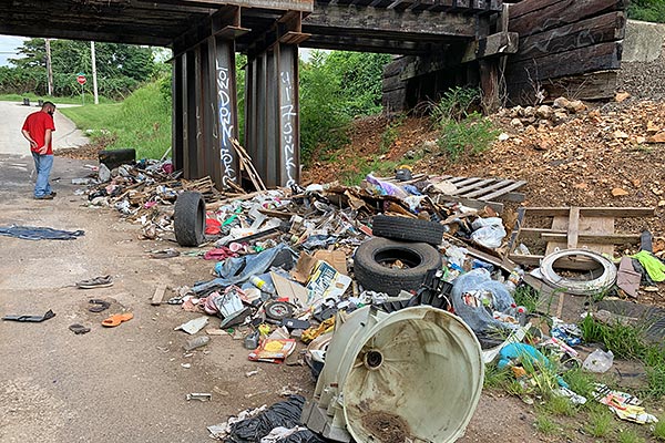 illegal dump site under railroad overpass